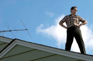 Larry Gopnik Stands Tall Atop His Roof in the Coen Brothers' "A Serious Man." Image Courtesy of: Focus Features.